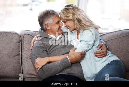 Youre all that matters in my world. a mature couple relaxing on the sofa together at home. Stock Photo