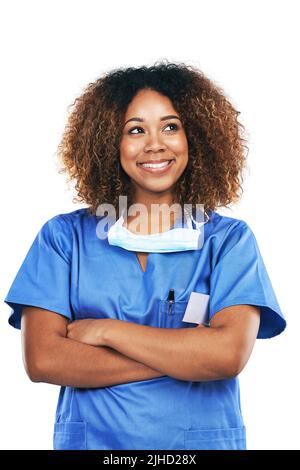 Making a difference with each day. Studio shot of an attractive young nurse looking thoughtful against a white background. Stock Photo