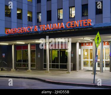 Seattle - July 09, 2022; Emergency and Trauma Center sign illuminated at Harborview Medical Center in Seattle over the entrance Stock Photo