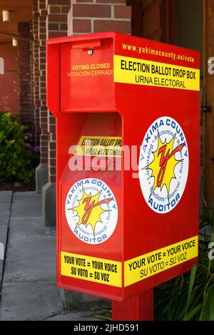 Yakima, WA, USA - July 11, 2022; Dual language red election ballot drop box for Yakima County Stock Photo