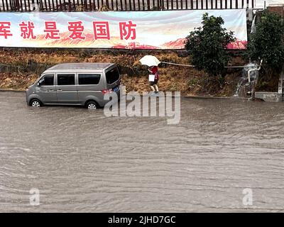 CHONGQING, CHINA - JULY 18, 2022 - Cars drive through water caused by torrential rain on Chongqing Road in Chongqing, China, July 18, 2022. Stock Photo