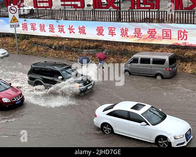 CHONGQING, CHINA - JULY 18, 2022 - Cars drive through water caused by torrential rain on Chongqing Road in Chongqing, China, July 18, 2022. Stock Photo