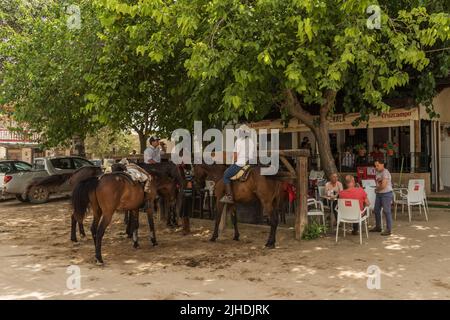 Horse riders on the sandy streets of El Rocío, Andalucia, Spain Stock Photo