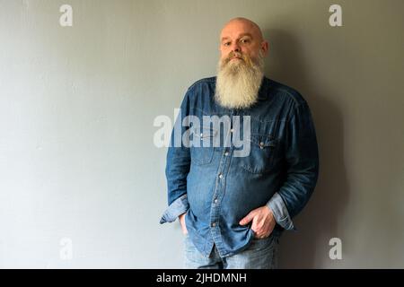 Tilburg, Netherlands. Portrait of a mature adult, caucasian male in front of a grey background. Stock Photo
