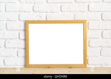 Photo frames on floor over white brick wall Stock Photo