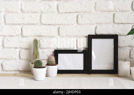 Square wooden photo frame and cactus plants on the table Stock Photo