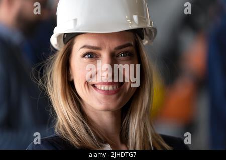 Portrait of female chief engineer in modern industrial factory looking at camera. Stock Photo