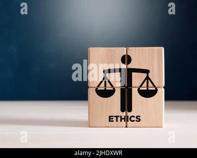 Business ethics or justice symbol on wooden cubes. Ethical corporate culture, business integrity and moral principles concept. Stock Photo