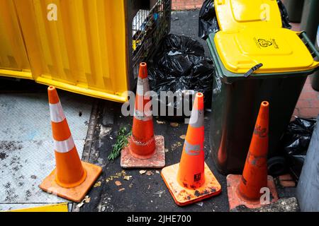Traffic cones and rubbish bins in a back alley, Wellington, North Island, New Zealand Stock Photo