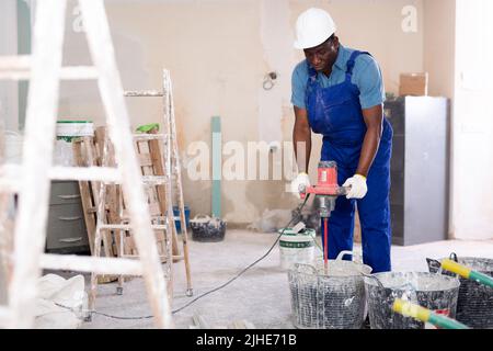 Portrait of an african american builder, working in the process of repair Stock Photo