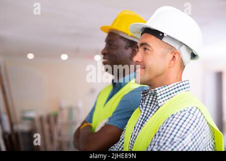 Positive engineers inspecting construction site Stock Photo