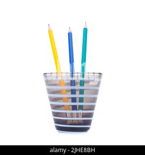 Pencils green blue yellow in the pencil holders on white background Stock Photo