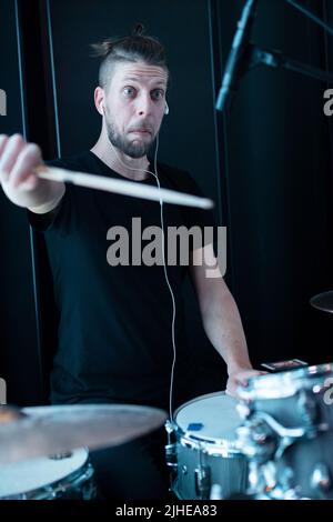 Young emotional funny drummer playing drum kit Stock Photo