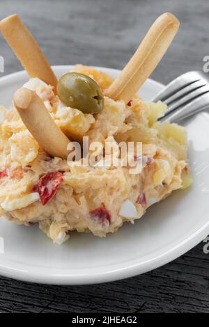 Tapa typical of Spain, Russian potato salad, egg, tuna and olives Stock Photo
