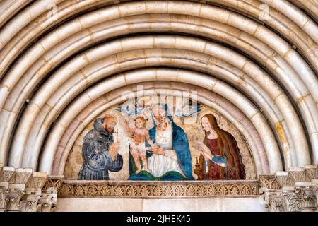 Lunette with a fresco of the Madonna con il Bambino between San Francesco and the Magdalene on the portal of the Church of San Francesco della Scarpa, Sul Stock Photo