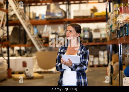 Woman warehouse worker checking inventory Stock Photo