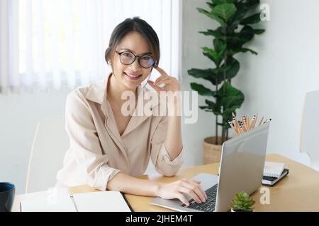 new normal, a businesswoman useing computer to work for a company Via the internet on your desk at home Stock Photo