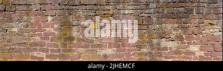 Old, heavily weathered panoramic stone wall Stock Photo