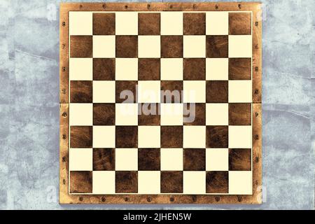 Brown dark chessboard on a gray marble surface Stock Photo