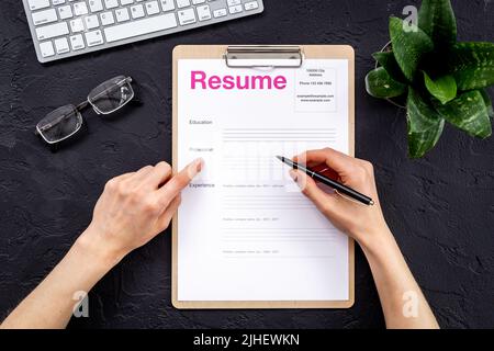 Job seeker or HR manager review resume on office table Stock Photo
