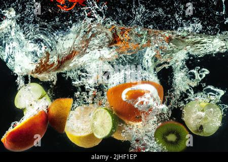 many fruits splashes into water Stock Photo