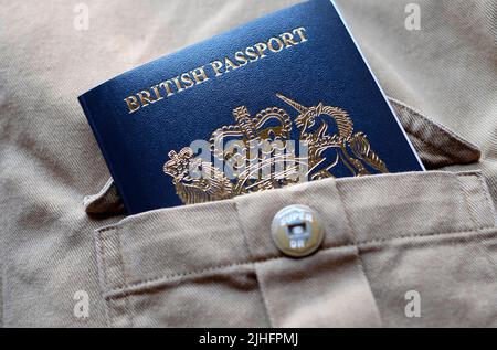 new british passport in beige shirt pocket Stock Photo