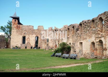 Dobele Castle Ruins in Latvia. The medieval stone walls with the central building in a panoramic view after restoration and rebuilding work. Stock Photo