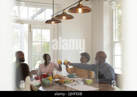Image of happy multi generation african american family eating breakfast Stock Photo