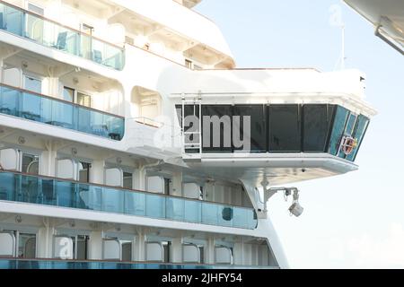 Bow and Bridge of a Massive Luxury Cruise Ship,Bridge Deck of Cruise Ship overlooking Downtown Office Buildings Stock Photo