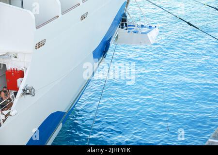 Ship's officer standing on the mooring plaform to oversee the safety of the berthing of this cruise liner Stock Photo