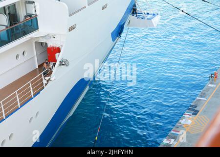 Ship's officer standing on the mooring plaform to oversee the safety of the berthing of this cruise liner Stock Photo