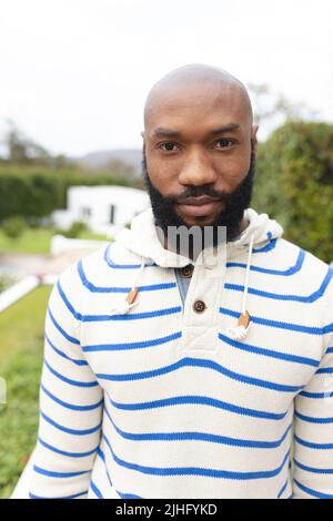 Vertical image of african american man in garden Stock Photo