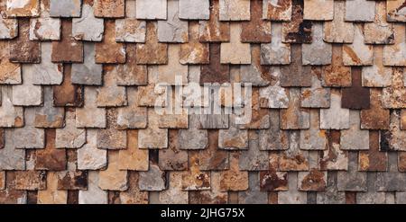 rust-brown slate wall, nature stone brick wall, slate tile background Stock Photo