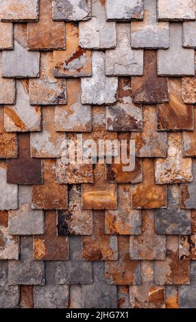 rust-brown slate wall, nature stone brick wall, slate tile background Stock Photo