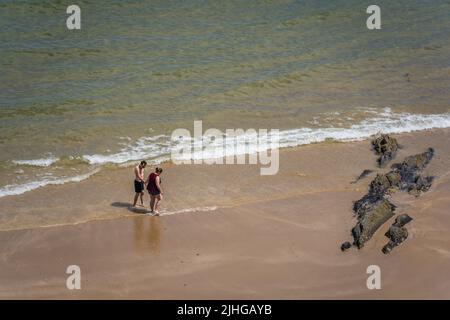 Tenby, Wales - May 2021 : People enjoying sunshine hot day on the Tenby town beach and coast, Carmarthen Bay, Pembrokeshire Stock Photo