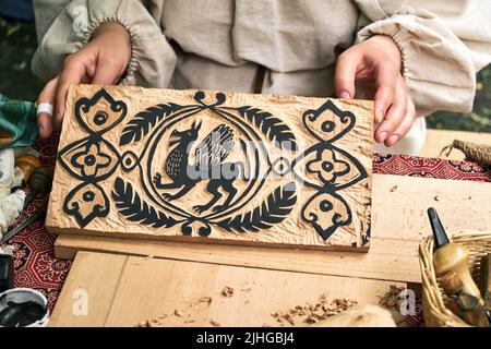 Wooden stamps for medieval ink printing on fabric and vintage clothing. Reconstruction of the events of the Middle Ages in Europe. Stock Photo