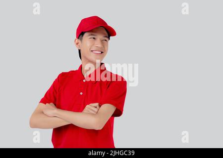 Young asian man in uniform red and cap standing arms crossed with confident isolated on white background, employee or dealer, courier and delivery, de Stock Photo