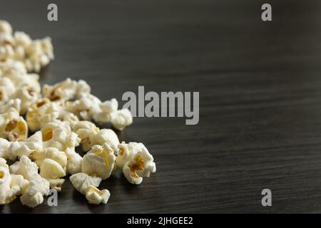 Border of freshly popped popcorn on a dark wood background with copy space Stock Photo