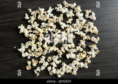 Background of freshly popped popcorn on a dark wood background with copy space Stock Photo