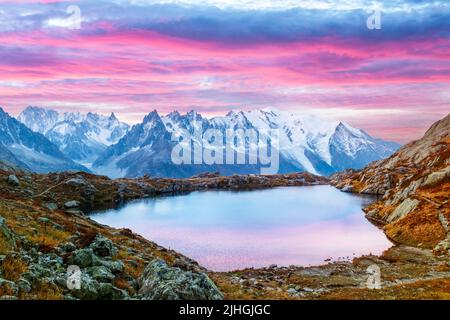 Colourful sunset on Chesery lake (Lac De Cheserys) in France Alps. Monte Bianco mountain range on background. Vallon de Berard Nature Preserve, Chamonix, Graian Alps. Landscape photography Stock Photo