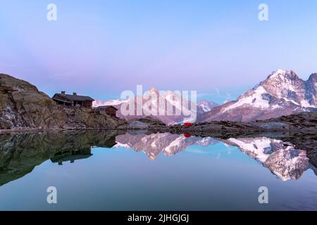 Colourful sunset on Lac Blanc lake in France Alps. Monte Bianco mountain range on background. Vallon de Berard Nature Preserve, Chamonix, Graian Alps. Landscape photography Stock Photo