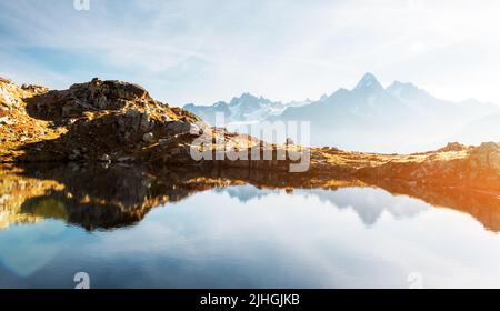 Colourful sunset on Chesery lake (Lac De Cheserys) in France Alps. Monte Bianco mountain range on background. Vallon de Berard Nature Preserve, Chamonix, Graian Alps. Landscape photography Stock Photo