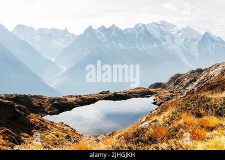 Colourful sunset on Chesery lake (Lac De Cheserys) in France Alps. Monte Bianco mountain range on background. Vallon de Berard Nature Preserve, Chamonix, Graian Alps. Landscape photography Stock Photo