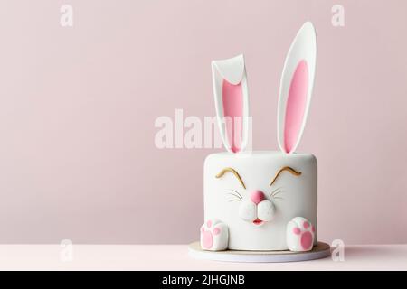 Easter bunny celebration cake on a pink background Stock Photo