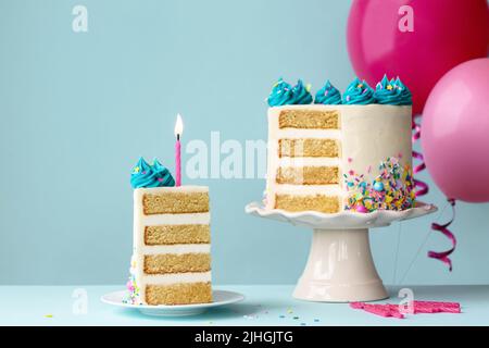 Birthday cake with layers and turquoise frosting, slice removed and one pink birthday candle Stock Photo