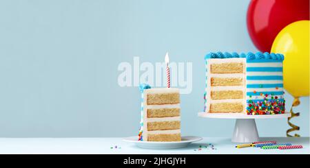 Slice of birthday cake with one red birthday candle and colorful birthday balloons ready for a birthday party Stock Photo