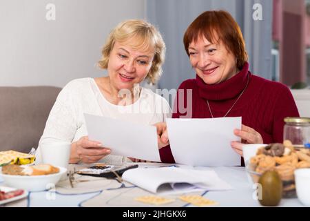 Cheerful elderly women with documents Stock Photo