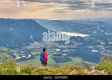 nice senior woman hiking at Mount Gruenten in the Allgaeu Alps with awesomw view over Iller valley to Lake Alpsee and Lake of Constanz, Bodensee,  Bav Stock Photo