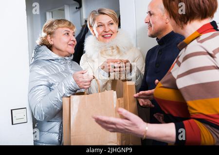 Mature friends are visiting their friend Stock Photo