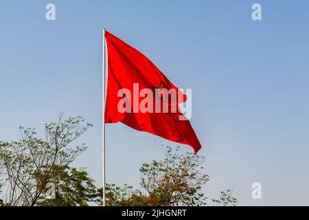 Isolated Moroccan flag with green star waving in a blue sky Stock Photo